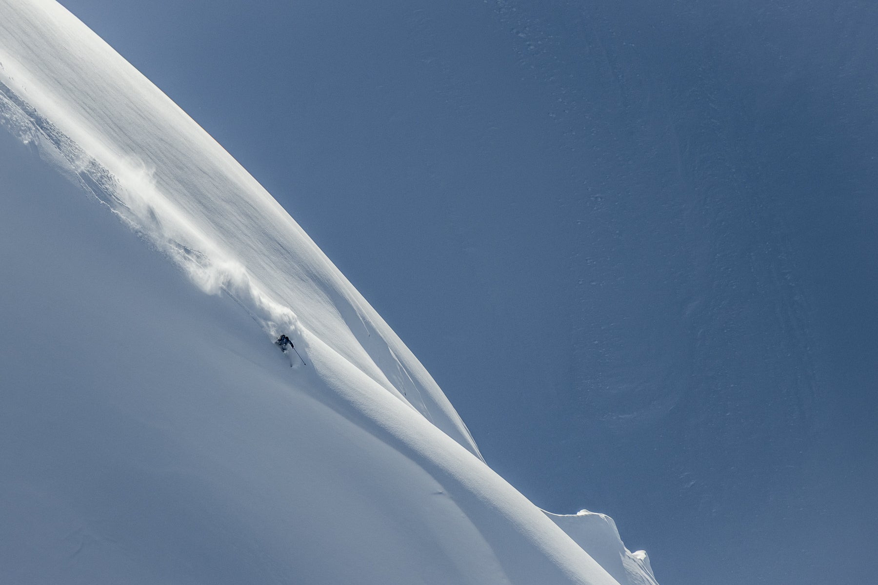 Skier on a huge alpine face