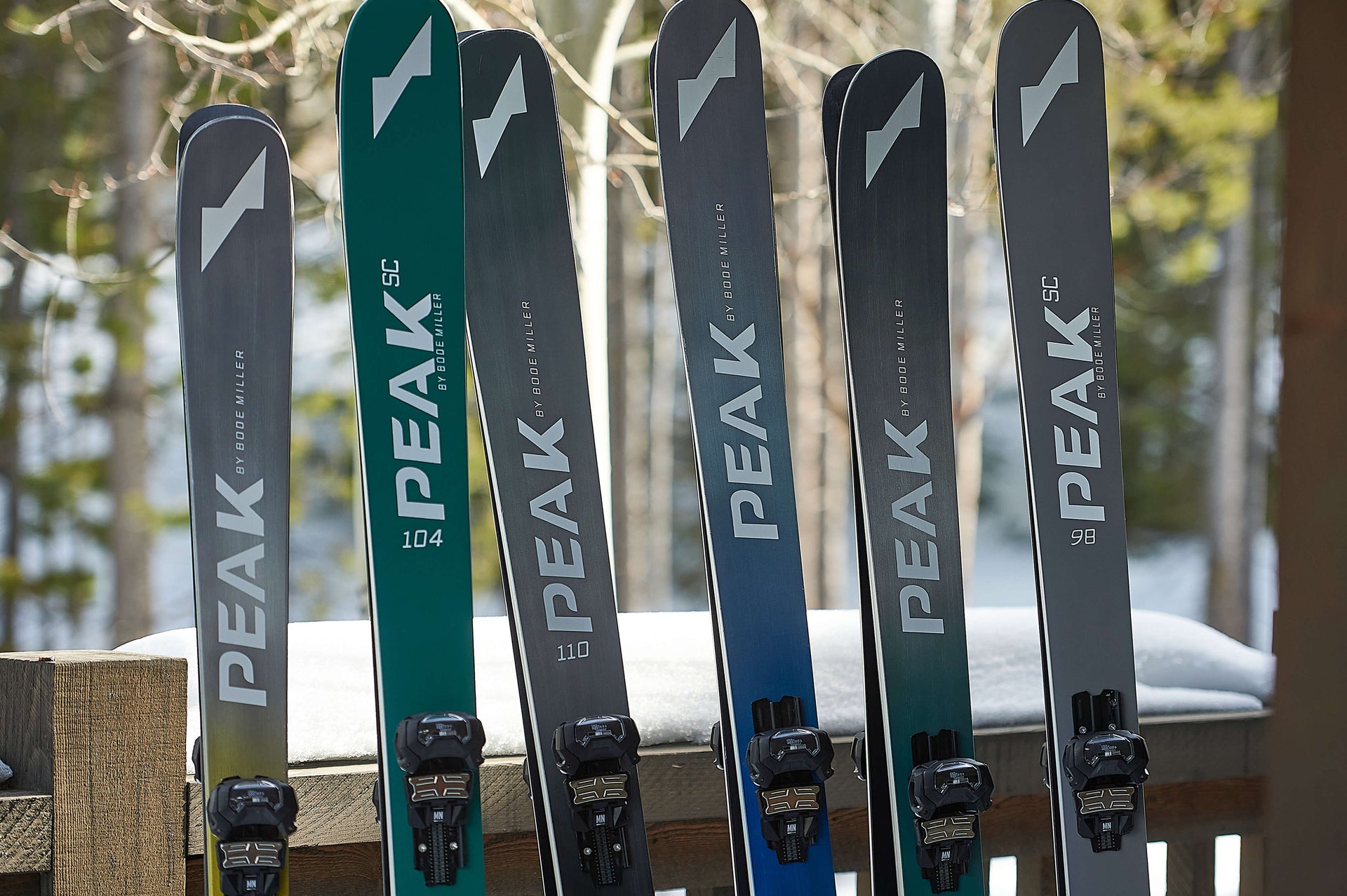 Sets of Peak skis leaning against a window