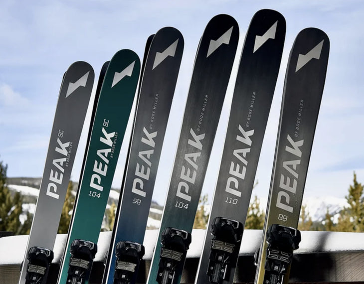 Peak Skis standing up in a line