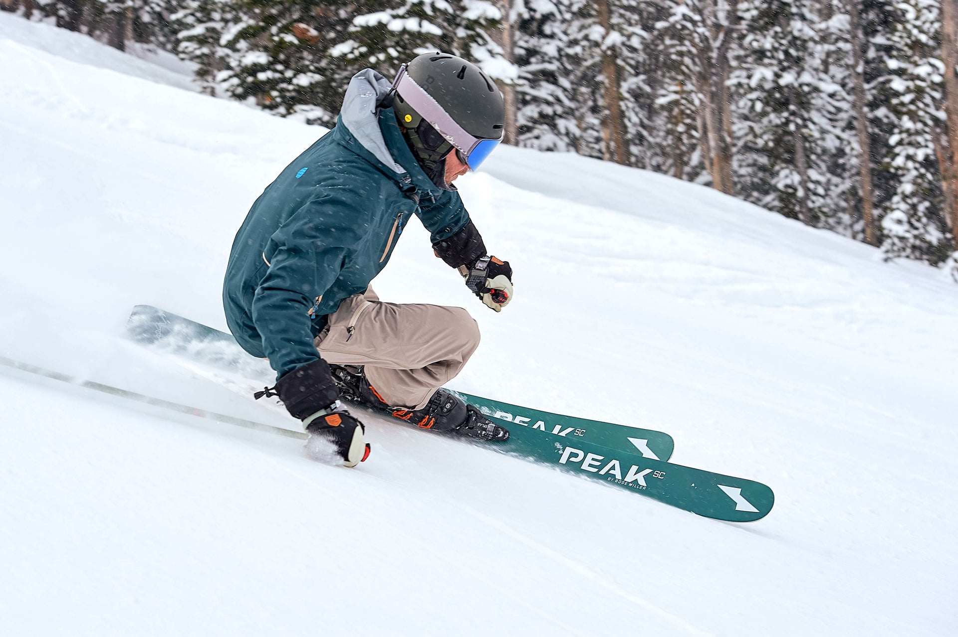 Skier laying down a carve on a groomer